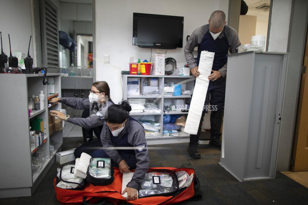 Ariana Cubillos Wearing masks as a precaution against the new coronavirus, Angels of the Road volunteer paramedics, Laura Lara, from left, Zully Rodiz and Jonathan Quantip, resupply their trauma kit, in Caracas, Venezuela, Monday, Feb. 8, 2021. These self-sufficient volunteers seek their own funding and operate entirely independent of government. (AP Photo/Ariana Cubillos)