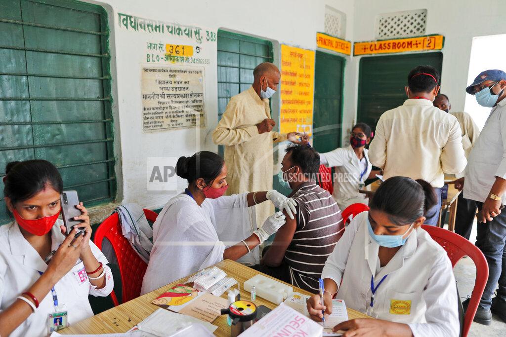 Rajesh Kumar Singh A vaccination drive against COVID-19 is in progress at a government school in Amritpur village, Uttar Pradesh state, India, on June 10, 2021. India's vaccination efforts are being undermined by widespread hesitancy and fear of the jabs, fueled by misinformation and mistrust. That's especially true in rural India, where two-thirds of the country’s nearly 1.4 billion people live. (AP Photo/Rajesh Kumar Singh)