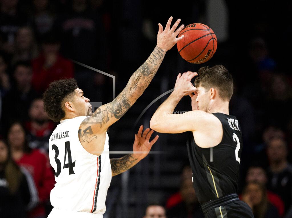 Albert Cesare Cincinnati guard Jarron Cumberland (34) knocks the ball from Central Florida guard Matt Milon (2) during the first half of an NCAA college basketball game Wednesday, Feb. 19, 2020, in Cincinnati. (Albert Cesare/The Cincinnati Enquirer via AP)