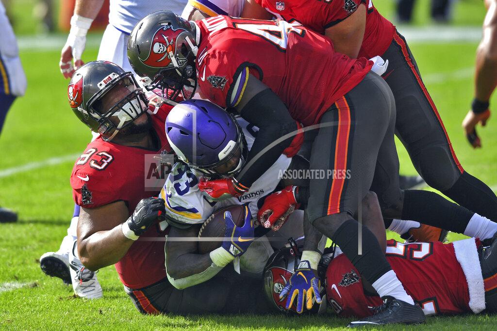 Jason Behnken Tampa Bay Buccaneers defensive end Ndamukong Suh (93) and inside linebacker Devin White (45) team up to stop Minnesota Vikings running back Dalvin Cook (33) during the first half of an NFL football game Sunday, Dec. 13, 2020, in Tampa, Fla. (AP Photo/Jason Behnken)