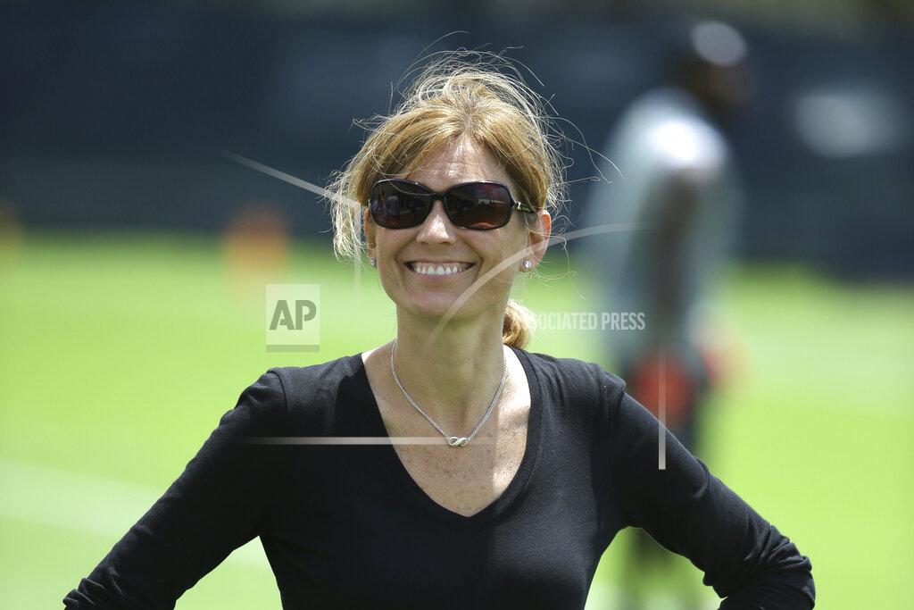 FILE - In this April 26, 2016, file photo, then-Miami Dolphins Executive Vice President of Football Administration Dawn Aponte stands on the field after a Miami Dolphins voluntary veterans football minicamp in Davie, Fla. For the past six-plus months, NFL football teams have been working virtually and eventually on the field to get ready for a season opener that came about despite the pain, tragedy and uneasiness caused by the coronavirus pandemic. Officiating crews have also been getting ready virtually for the most part, said Aponte, the NFL's chief football administrative officer.(AP Photo/Lynne Sladky, File)