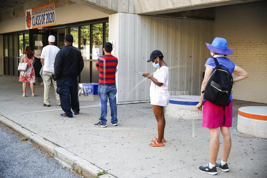 John Minchillo Voters wait in line to cast their ballots in New York's primary election at a polling station inside Yonkers Middle/High School, Tuesday, June 23, 2020, in Yonkers, N.Y. (AP Photo/John Minchillo)