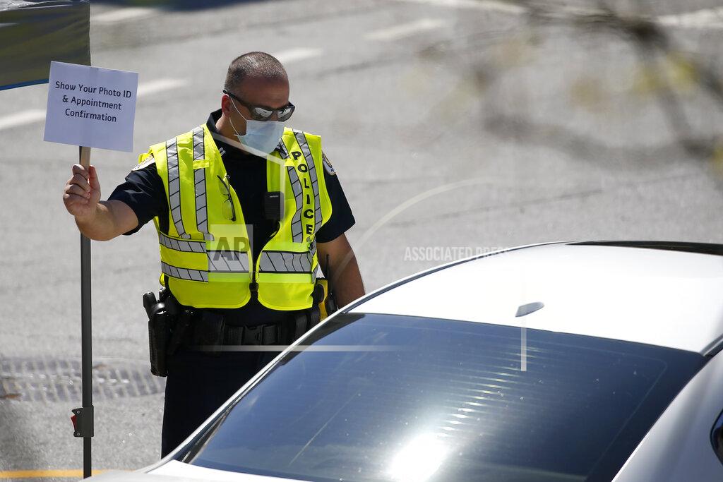 John Bazemore A police officer directs cars into a coronavirus testing facility at Georgia Tech Monday, April 6, 2020, in Atlanta. The testing is by appointment only and requires a referral. (AP Photo/John Bazemore)