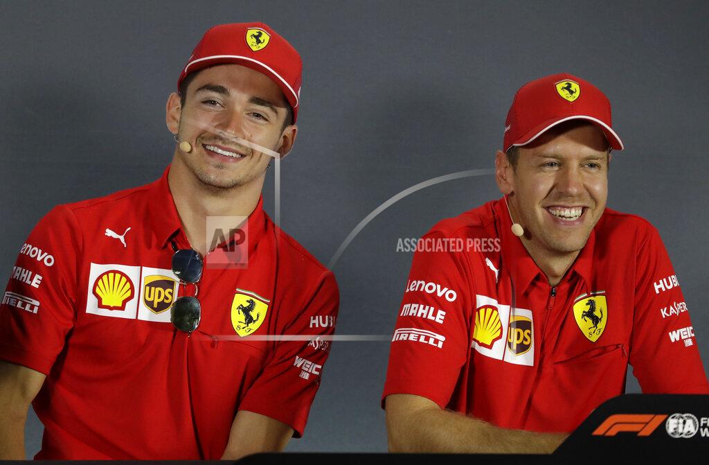 Luca Bruno Ferrari driver Charles Leclerc of Monaco, left, is flanked by his teammate Sebastian Vettel of Germany during a press conference at the Monza racetrack, in Monza, Italy , Thursday, Sept.5, 2019. The Formula one race will be held on Sunday. (AP Photo/Luca Bruno)
