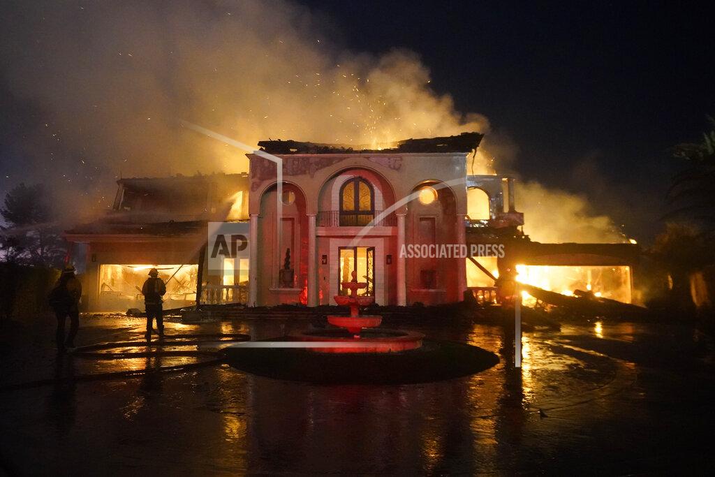 Marcio J. Sanchez Firefighters work to put out a structure burning during a wildfire Wednesday, May 11, 2022, in Laguna Niguel, Calif. (AP Photo/Marcio J. Sanchez)