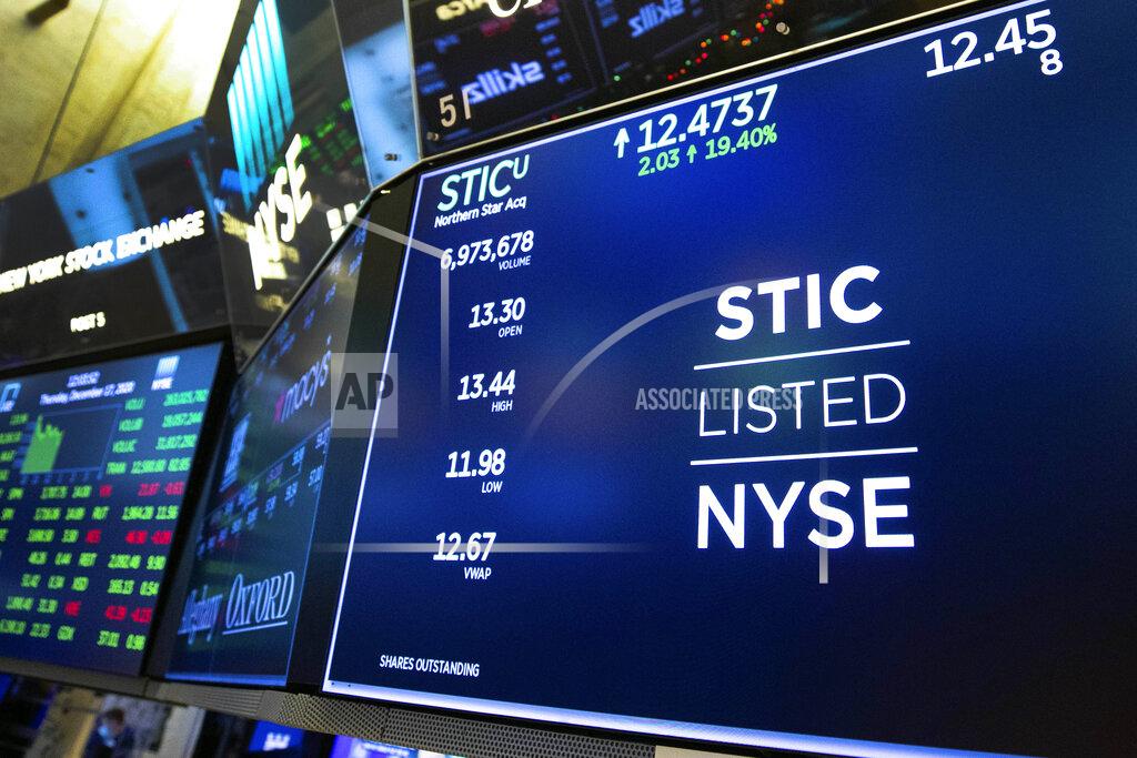 In this photo provided by the New York Stock Exchange, a board above a trading post on the floor, shows the symbol for Northern Star Acquisition Corp., Thursday, Dec. 17, 2020. Bark is heading to the stock market through a $1.6 billion deal in which Northern Star Acquisition Corp. buys the company and takes it public. (Colin Ziemer/New York Stock Exchange via AP)