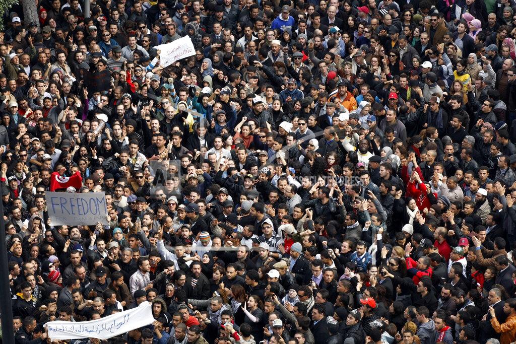 Christophe Ena Protesters chant slogans against President Zine El Abidine Ben Ali during a demonstration in Tunis, Friday, Jan. 14, 2011. Thousands of angry demonstrators marched through Tunisia's capital Friday, demanding the resignation of the country's autocratic leader a day after he appeared on TV to try to stop deadly riots that have swept the North African nation. (AP Photo/Christophe Ena)