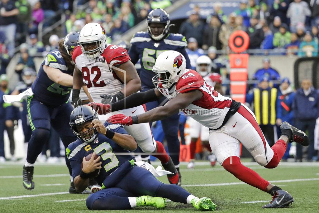 Lindsey Wasson Seattle Seahawks quarterback Russell Wilson (3) slides to avoid a tackle by Arizona Cardinals linebacker Chandler Jones, right, during the first half of an NFL football game, Sunday, Dec. 22, 2019, in Seattle. (AP Photo/Lindsey Wasson)