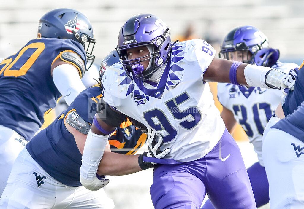 William Wotring TCU defensive tackle Terrell Cooper (95) works around West Virginia offensive lineman Zach Frazier (54) during the first half of an NCAA college football game on Saturday, Nov. 14, 2020, in Morgantown, W.Va. (William Wotring/The Dominion-Post via AP)
