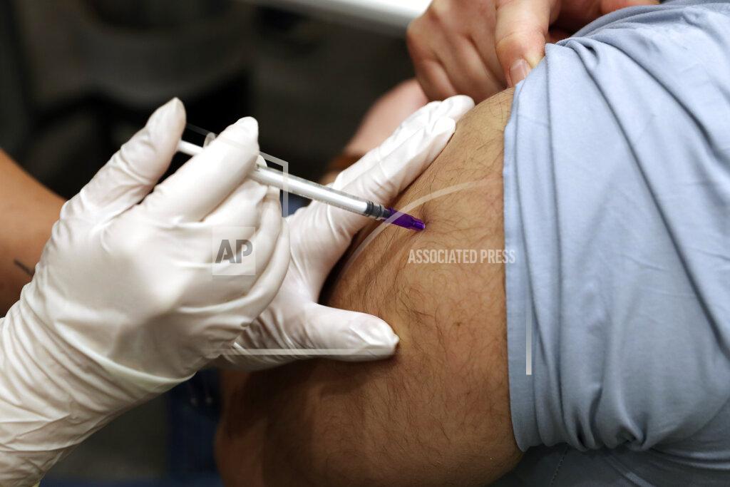 Bilal Hussein A healthcare worker receives Pfizer-BioNTech COVID-19 vaccine during a nationwide vaccination program at the American University Medical Center in Beirut, Lebanon, Sunday, Feb. 14, 2021. (AP Photo/Bilal Hussein)