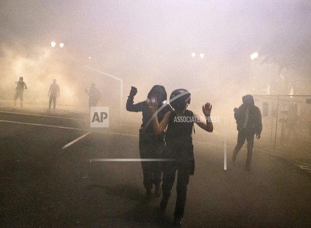 Beth Nakamura Protesters gather during a demonstration in Portland, Ore., Thursday, July 16, 2020. Federal officers deployed tear gas and fired less-lethal rounds into a crowd of protesters late Thursday. The actions came just hours after the head of the Department of Homeland Security called the protesters “violent anarchists.” (Beth Nakamura/The Oregonian via AP)