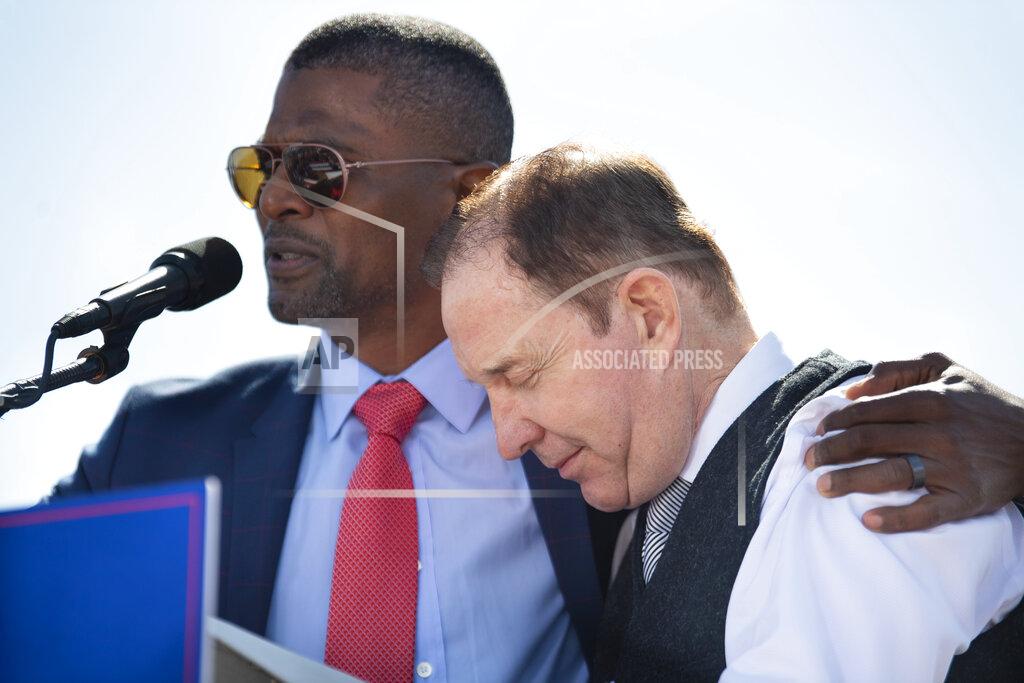 Kenneth Ferriera Former NFL player Jack Brewer, left, says a prayer with Nebraska Republican gubernatorial candidate Charles Herbster for his accusers to be cast out during a campaign rally, Sunday, May 1, 2022, in Greenwood, Neb. (Kenneth Ferriera/Lincoln Journal Star via AP)