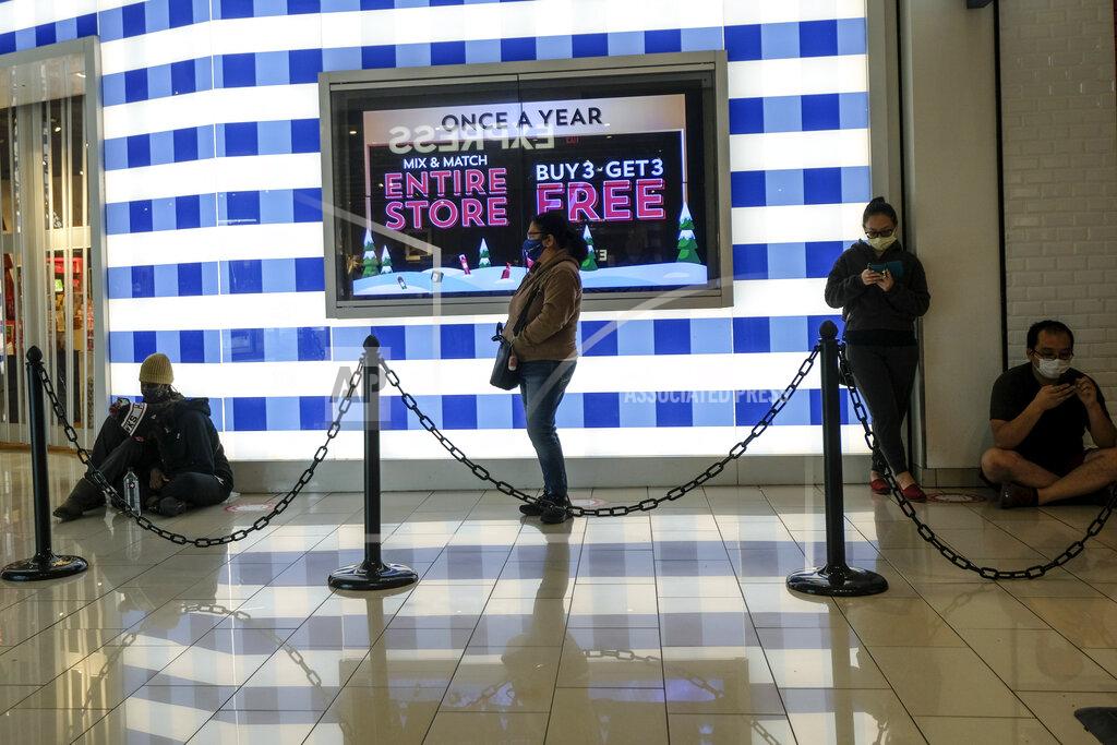 Ringo H.w. Chiu Black Friday shoppers wearing face masks wait in line to enter a store at the Glendale Galleria in Glendale, Calif., Friday, Nov. 27, 2020. (AP Photo/Ringo H.W. Chiu)