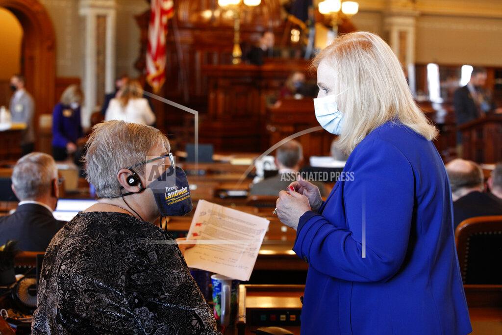 John Hanna Kansas state Reps. Brenda Landwehr, left, R-Wichita, and Susan Concannon, R-Beloit, confer during a House debate on a proposed anti-abortion amendment to the Kansas Constitution, Friday, Jan. 22, 2021, at the Statehouse in Topeka, Kan. Both supported the measure, which would overturn a Kansas Supreme Court decision in 2019 that declared access to abortion a "fundamental" right under the state constitution. (AP Photo/John Hanna, Pool)