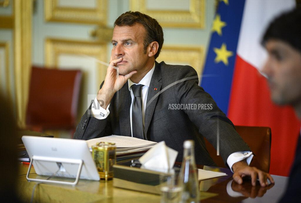 Eliot Blondet French President Emmanuel Macron attends a video European Council summit at the Elysee Palace in Paris, Friday, June 19, 2020. As they brace for the worst economic downturn since the Great Depression, leaders of the European Union's 27 member states discuss Friday the bloc's future long-term budget and a multi-billion post-coronavirus recovery plan during a video-summit aimed at paving the way for a compromise later this summer. (Eliot Blondet/Pool Photo via AP)