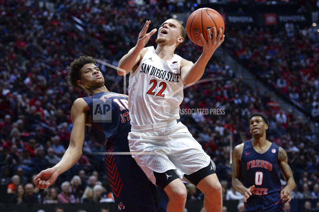 Orlando Ramirez San Diego State guard Malachi Flynn (22) goes to the basket while defended by Fresno State forward Orlando Robinson (10) during the second half of an NCAA college basketball game Wednesday, Jan. 1, 2020, in San Diego. San Diego won 61-52. (AP Photo/Orlando Ramirez)