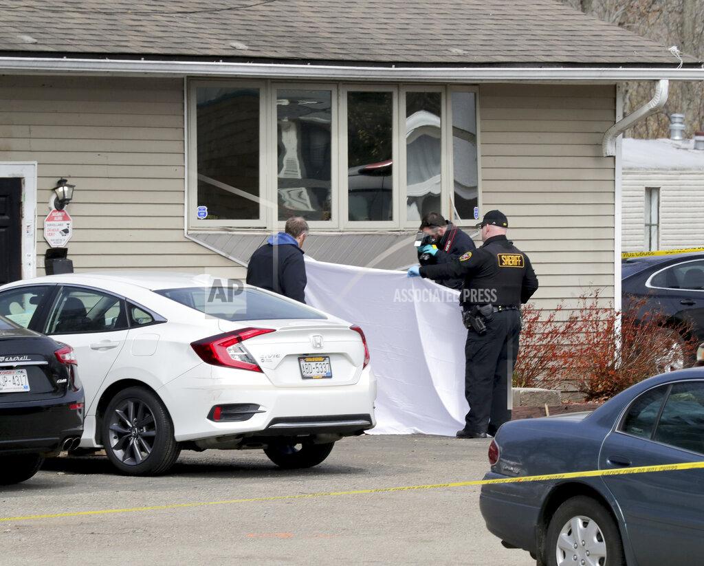 Mike De Sisti Officials investigate the scene of an early Sunday fatal shooting at Somers House Tavern in Kenosha, Wis., on Sunday, April 18 2021. (Mike De Sisti/Milwaukee Journal-Sentinel via AP)