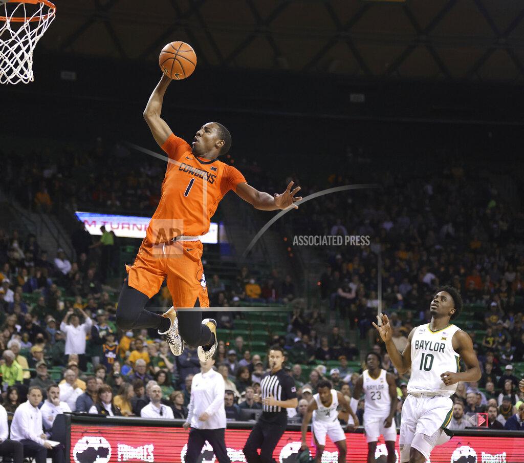 Rod Aydelotte Oklahoma State guard Bryce Thompson scores over Baylor guard Adam Flagler (10) in the first half of an NCAA college basketball game, Saturday, Jan. 15, 2022, in Waco, Texas. (Rod Aydelotte/Waco Tribune Herald, via AP)
