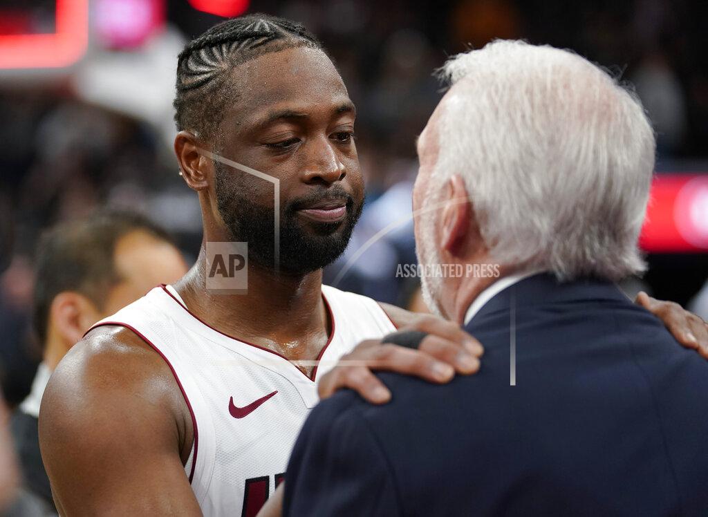 Miami Heat guard Dwyane Wade, left, embraces San Antonio Spurs coach Gregg Popovich after an NBA basketball game Wednesday, March 20, 2019, in San Antonio. Miami won 110-105. (AP Photo/Darren Abate)