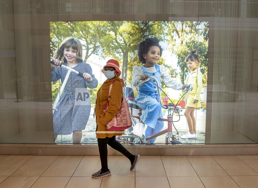 Elizabeth Flores A shopper makes her way through Rosedale Center as some of the stores opened for business during the coronavirus pandemic, Monday, May 18, 2020 in Roseville, Minn. (Elizabeth Flores/Star Tribune via AP)