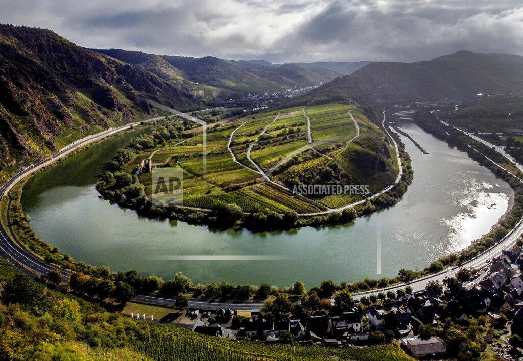 Michael Probst File---File picture taken Sept. 26, 2020 shows he Calmont vineyard standing over the Mosel loop in Bremm, Germany. The German disease control agency is adding France's Moselle region to its list of areas with a high rate of variant coronavirus cases, meaning travelers from there will face additional hurdles when crossing the border into neighboring Germany.(AP Photo/Michael Probst, file)