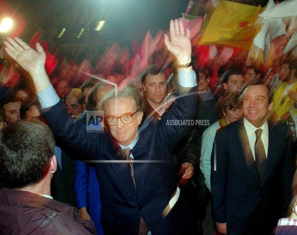 Armando Franca FILE - In this Jan. 13 1996 file photo, presidential candidate Jorge Sampaio waves to supporters upon arriving for his last campaign rally escorted by a smiling Portuguese Prime Minister Antonio Guterres, right, in Lisbon. Sampaio, a former two-term president of Portugal and one of the most prominent political figures of his generation, has died. He was 81. The current Portuguese president, Marcelo Rebelo de Sousa, announced Sampaio's death Friday, Sept 10, 2021. (AP Photo/Armando Franca, File)