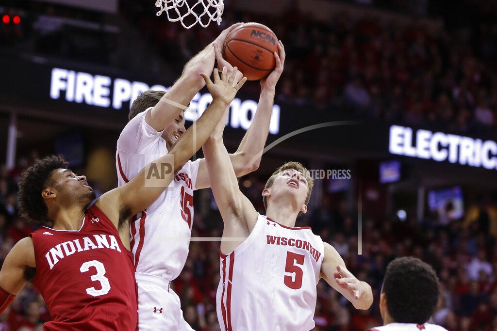 Andy Manis Wisconsin's Nate Reuvers, center, and Tyler Wahl (5) go after a defensive rebound against Indiana's Justin Smith (3) during the first half of an NCAA college basketball game Saturday, Dec. 7, 2019, in Madison, Wis. (AP Photo/Andy Manis)