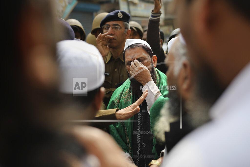Altaf Qadri FILE - In this Friday, Feb. 28, 2020, file photo, a man gestures as a senior Delhi police officer speaks to a group of Muslims ahead of Friday prayers near a heavily-policed fire-bombed mosque in New Delhi, India. Many of the Muslim victims of last year's bloody violence say they have run repeatedly into a refusal by police to investigate complaints against Hindu rioters. Some hope the courts will still come to their help. But others now believe the justice system under Prime Minister Narendra Modi's Hindu-nationalist government has become stacked against them. (AP Photo/Altaf Qadri, File)