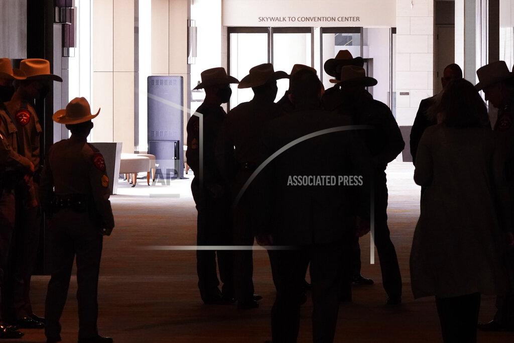Lm Otero Texas DPS officers gather near a closed walkway to the Dallas convention center before a news conferenced about migrant children detentions Wednesday, March 17, 2021, in Dallas. (AP Photo/LM Otero)