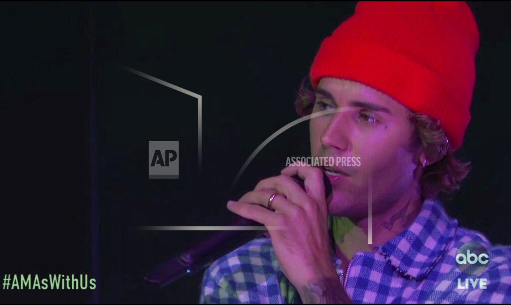 Uncredited In this screen shot provided by ABC on Sunday, Nov. 22, 2020, Justin Bieber performs at the American Music Awards at the Microsoft Theater in Los Angeles. (ABC via AP)