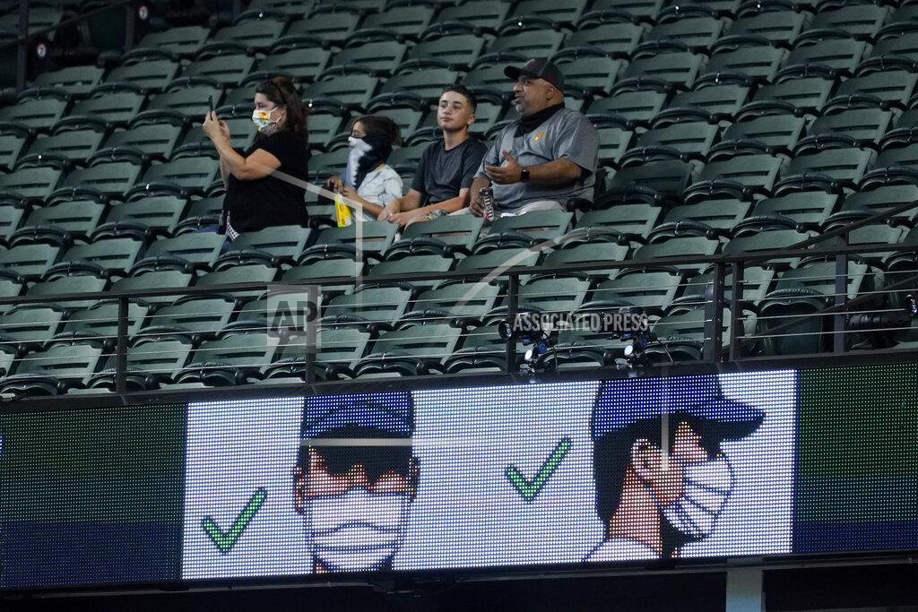 Tony Gutierrez Fans watch during batting practice before Game 1 of a baseball National League Championship Series between the Los Angeles Dodgers and the Atlanta Braves Monday, Oct. 12, 2020, in Arlington, Texas. (AP Photo/Tony Gutierrez)