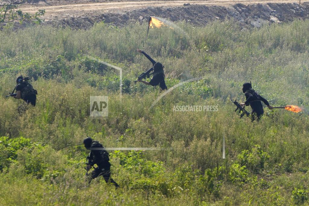 Ng Han Guan Participants playing the role of terrorists attack a United Nations base during the Shared Destiny 2021 drill at the Queshan Peacekeeping Operation training base in Queshan County in central China's Henan province Wednesday, Sept. 15, 2021. Peacekeeping troops from China, Thailand, Mongolia and Pakistan took part in the 10 days long exercise that field reconnaissance, armed escort, response to terrorist attacks, medical evacuation and epidemic control. (AP Photo/Ng Han Guan)