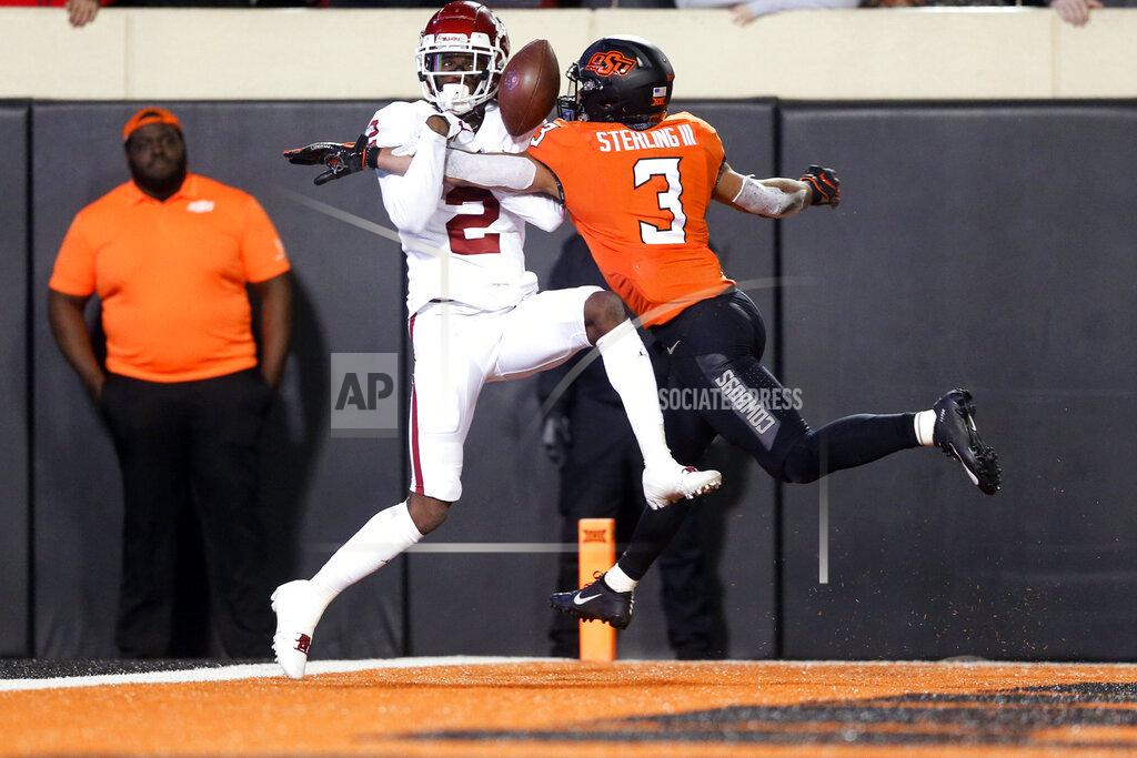 Ian Maule Oklahoma wide receiver CeeDee Lamb (2) attempts to make a catch in the end zone while being defended by Oklahoma State safety Tre Sterling (3) during an NCAA college football game, Saturday, Nov. 30, 2019, in Stillwater, Okla. (Ian Maule/Tulsa World via AP)