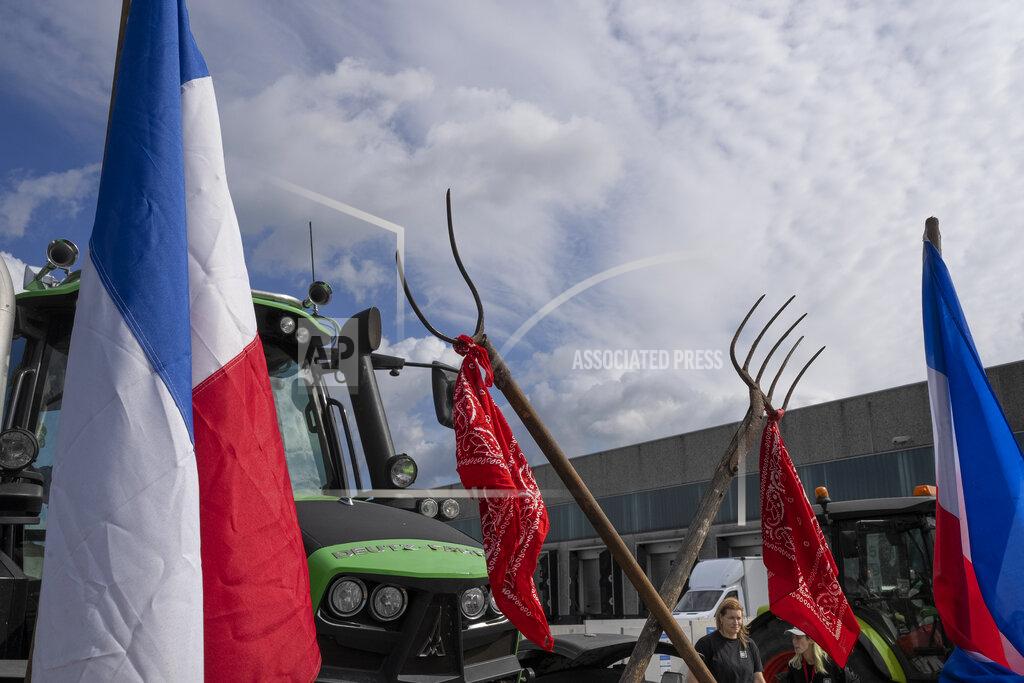 Peter Dejong Some 25 tractors were used to blockade a distribution center for supermarket chain Albert Heijn in the town of Zaandam, just north of Amsterdam, Monday, July 4, 2022. Dutch farmers angry at government plans to slash emissions used tractors and trucks Monday to blockade supermarket distribution centers, the latest actions in a summer of discontent in the country's lucrative agricultural sector. (AP Photo/Peter Dejong)