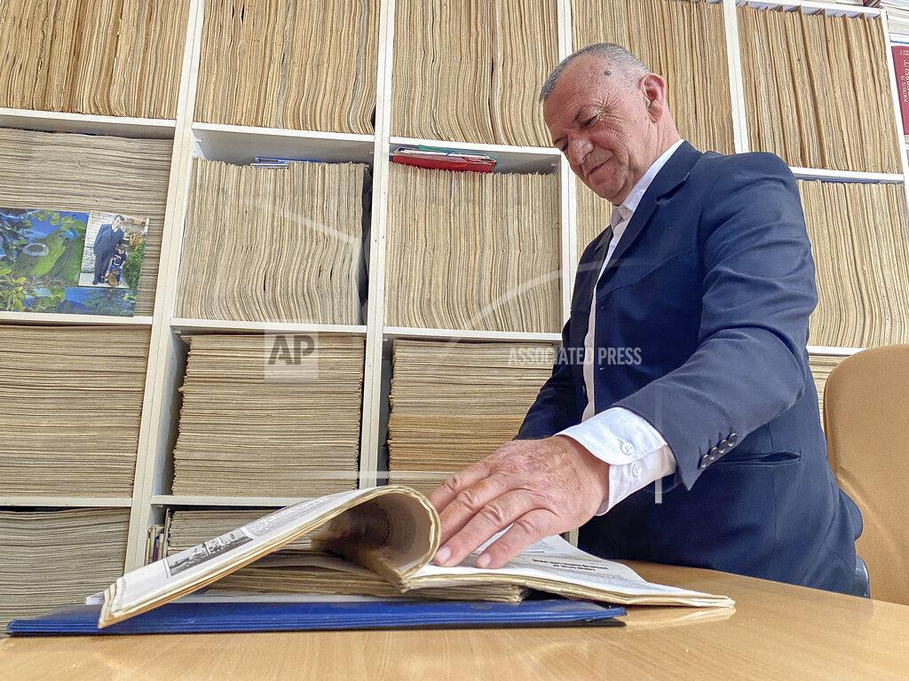Visar Kryeziu Azem Qerkini, an accountant and newspaper collector shows copies from his newspaper archive, in Ferizaj, Kosovo, Friday, April 30, 2021. The printing presses stopped running at the start of the pandemic in Kosovo. The country's five dailies all stopped printing physical newspapers and turned into online media portals. But these do not reach all the people as before, and many fear they prioritise speed over accuracy. (AP Photo/Visar Kryeziu)