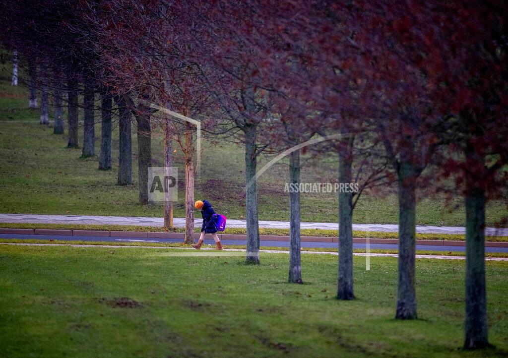 Michael Probst A girl goes to school which in Frankfurt, Germany, Monday, Dec. 14, 2020. Germany goes into a lockdown on Wednesday, Dec. 16, 2020. (AP Photo/Michael Probst)