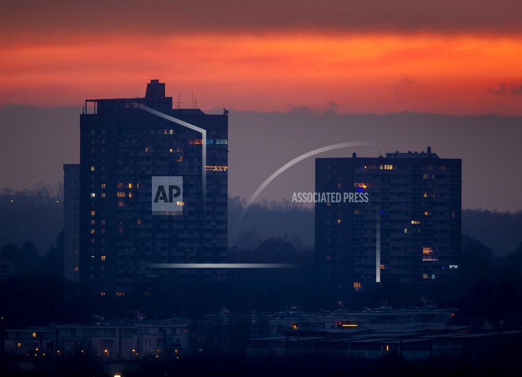 Michael Probst Lights burn in two apartment houses in Frankfurt, Germany, Friday, Dec. 11, 2020, as the German government discusses further restrictions to avoid the outspread of the coronavirus. (AP Photo/Michael Probst)