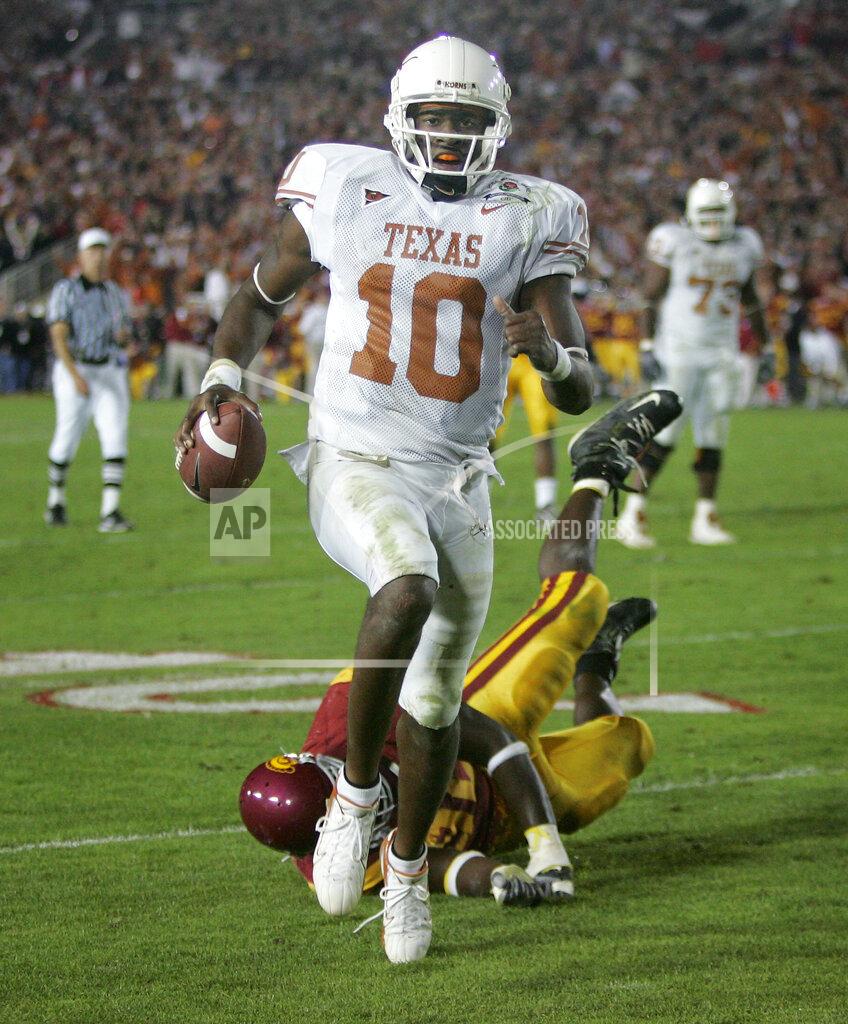 Paul Sakuma FILE - In this Jan. 4, 2006, file photo, Texas quarterback Vince Young rushes for the game-winning touchdown against Southern California during the Rose Bowl college football game in Pasadena, Calif. USC’s run at No. 1 ended in the 2006 Rose Bowl, which was also one of the best games of the decade. Texas _ led by coach Mack Brown and quarterback Vince Young _ topped the Trojans 41-38 in a back-and-forth thriller. (AP Photo/Paul Sakuma, File)
