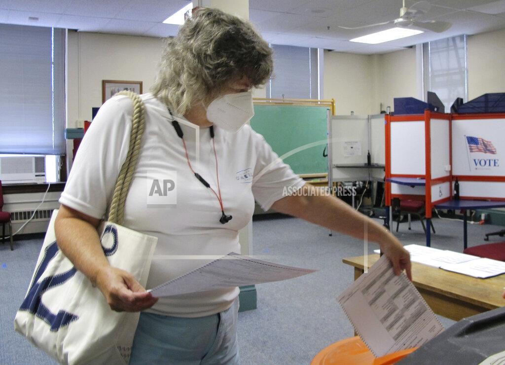 Lisa Rathke Voter Diana Tierney files her ballot in Vermont's statewide primary on Tuesday, Aug. 11, 2020, in Montpelier, Vt. (AP Photo/Lisa Rathke)