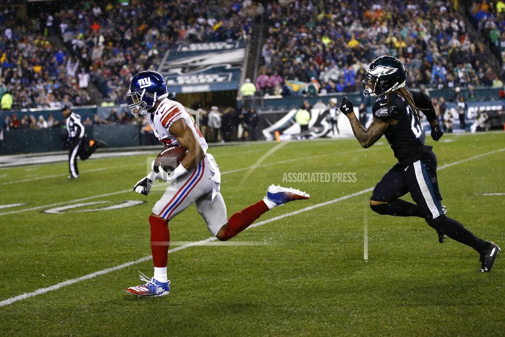 Michael Perez New York Giants' Darius Slayton, left, runs past Philadelphia Eagles' Ronald Darby to score a touchdown during the first half of an NFL football game, Monday, Dec. 9, 2019, in Philadelphia. (AP Photo/Michael Perez)