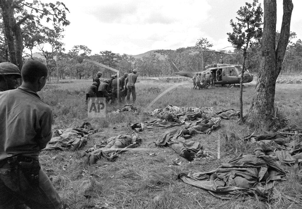 Rick Merron FILE - In this Nov. 18, 1965 file photo, U.S. troops carry bodies of air cavalrymen to an evacuation helicopter as more bodies lie on the ground at the site of an ambush by communist forces in the Ia Drang valley in Vietnam. In April 2020, the U.S.' coronavirus death toll surpassed the 58,220 American service members killed in Vietnam, which suffered over one million civilian and military deaths during the war. Vietnam has reported no COVID-19 deaths and less than 300 virus infections. (AP Photo/Rick Merron)