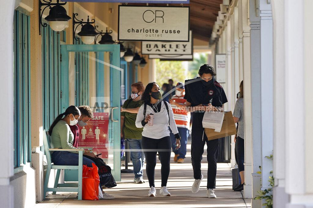 Chris O'meara Shoppers wear protective face masks as they look for Black Friday deals at the Ellenton Premium Outlet stores Friday, Nov. 27, 2020, in Ellenton, Fla. Attendance at the mall was down in an attempt to avoid spreading the corona virus. (AP Photo/Chris O'Meara)