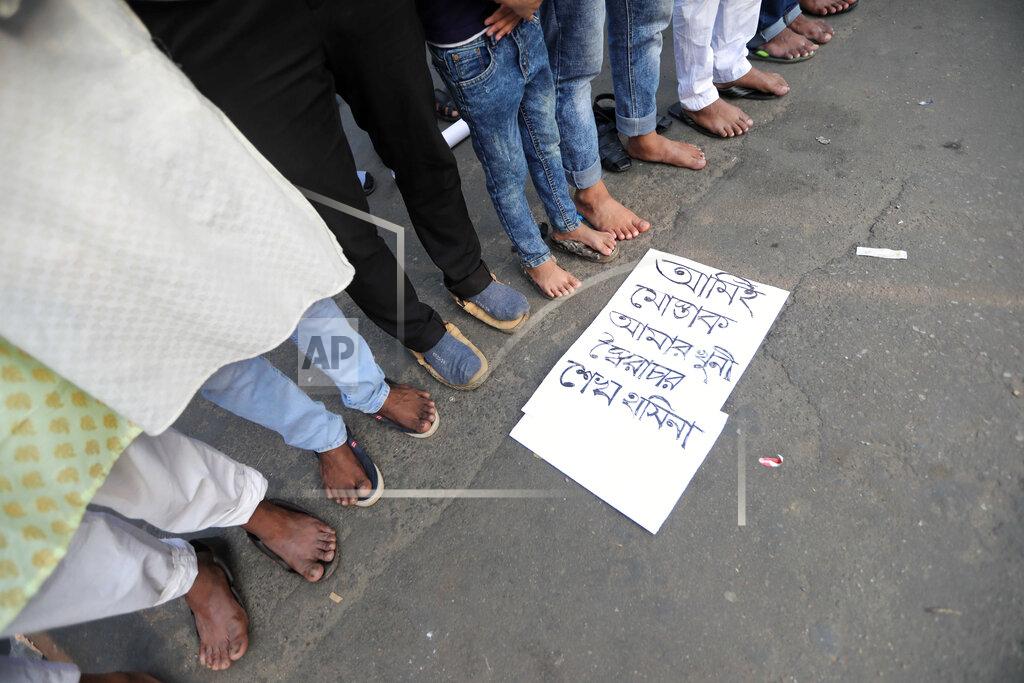 Mahmud Hossain Opu Protesters offer Friday prayers during a demonstration against the death in prison of a writer who was arrested on charges of violating the sweeping digital security, in Dhaka, Bangladesh, Friday, Feb. 26, 2021. Mushtaq Ahmed, 53, was arrested in Dhaka in May last year for making comments on social media that criticized the Prime Minister Sheikh Hasina government's handling of the coronavirus pandemic. He had been denied bail at least six times. The poster reads "I am Mushtaq and autocrat Sheikh Hasina is my killer." (AP Photo/Mahmud Hossain Opu)