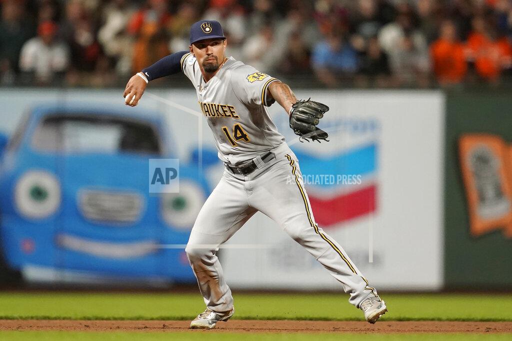 Jeff Chiu Milwaukee Brewers third baseman Jace Peterson (14) throws out San Francisco Giants' Wilmer Flores at first base during the sixth inning of a baseball game in San Francisco, Monday, Aug. 30, 2021. (AP Photo/Jeff Chiu)