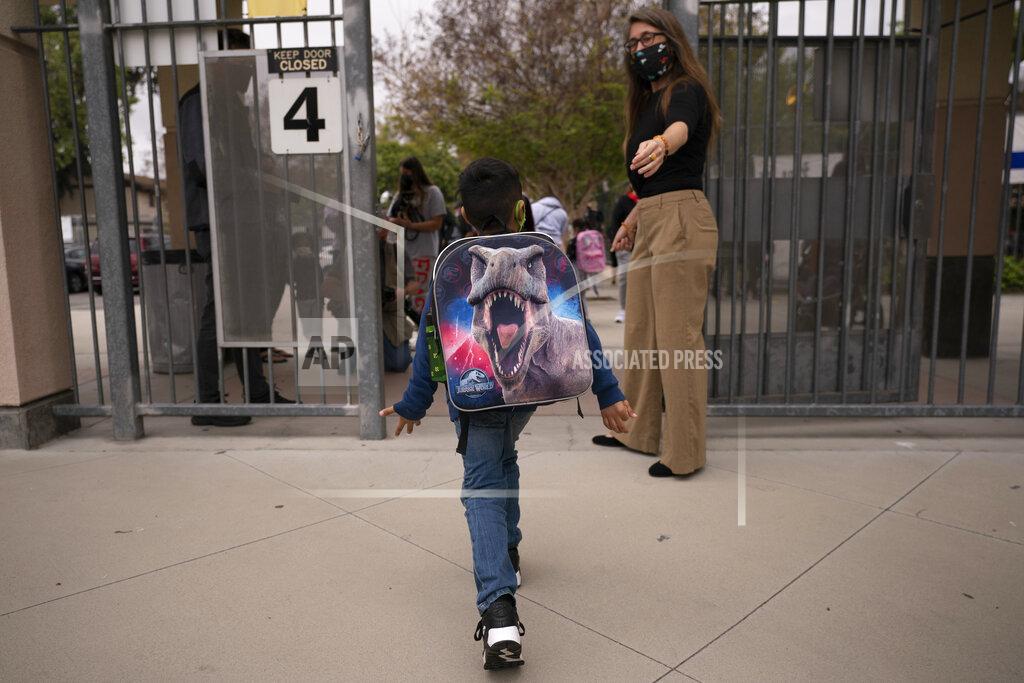 Jae C. Hong FILE - Kindergartener Angel Hernandez leaves after the first day of in-person learning at Maurice Sendak Elementary School in Los Angeles, Tuesday, April 13, 2021. A recent spike in coronavirus cases in some states has led one of the nation's top health experts to suggest that governors could “close things down” like they did during previous surges. But that doesn't appear likely to happen — not even in states led by Democratic governors who favored greater restrictions in the past. (AP Photo/Jae C. Hong)