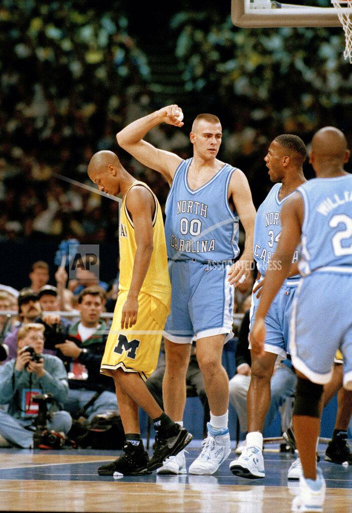 Uncredited FILE - In this April 5, 1993, file photo, North Carolina's Eric Montross (00) and George Lynch celebrate a basket as Michigan's Jalen Rose, left, walks away during first half of their NCAA Final Four championship game at the Superdome in New Orleans. North Carolina beat Michigan 77-71. (AP Photo/Susan Ragan, Fle)