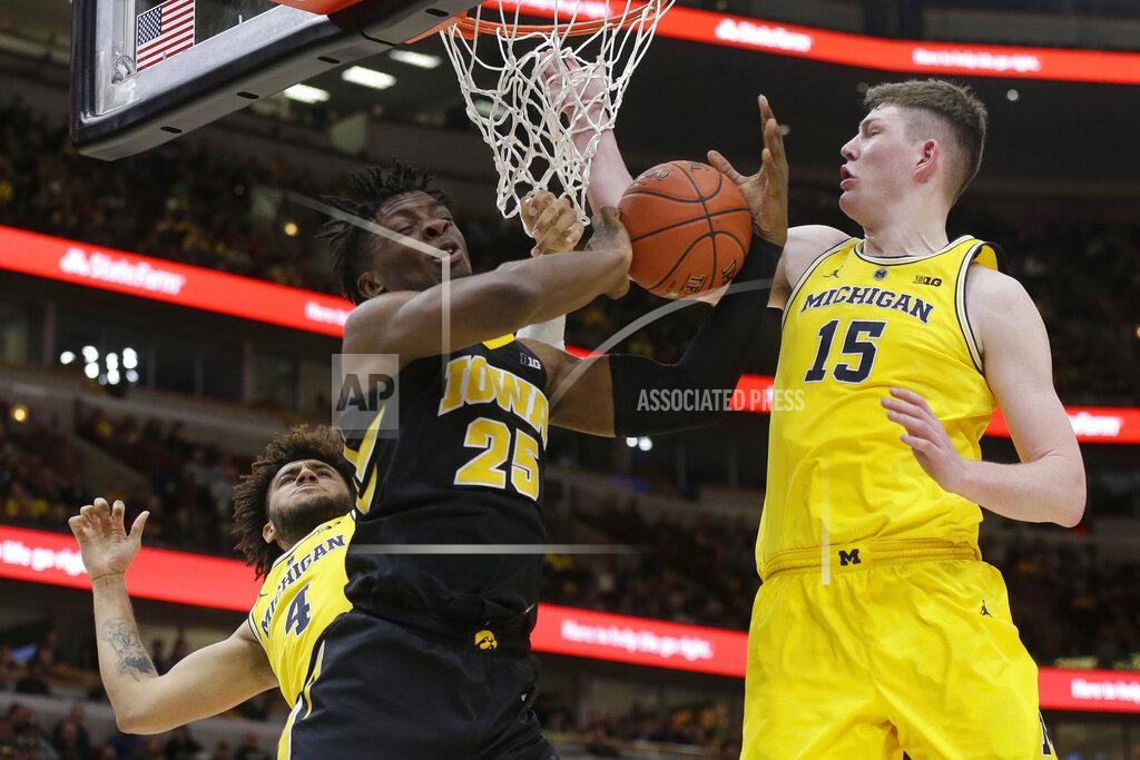 Kiichiro Sato Michigan's Isaiah Livers (4) and Jon Teske (15) block a shot by Iowa's Tyler Cook (25) during the second half of an NCAA college basketball game in the quarterfinals of the Big Ten Conference tournament, Friday, March 15, 2019, in Chicago. (AP Photo/Kiichiro Sato)