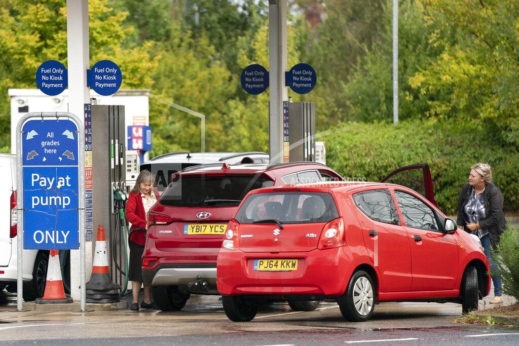 Jon Super Members of the public are seen at a petrol station in Manchester, England, Monday, Sept. 27, 2021. British Prime Minister Boris Johnson is said to be considering whether to call in the army to deliver fuel to petrol stations as pumps ran dry after days of panic buying. ( AP Photo/Jon Super)