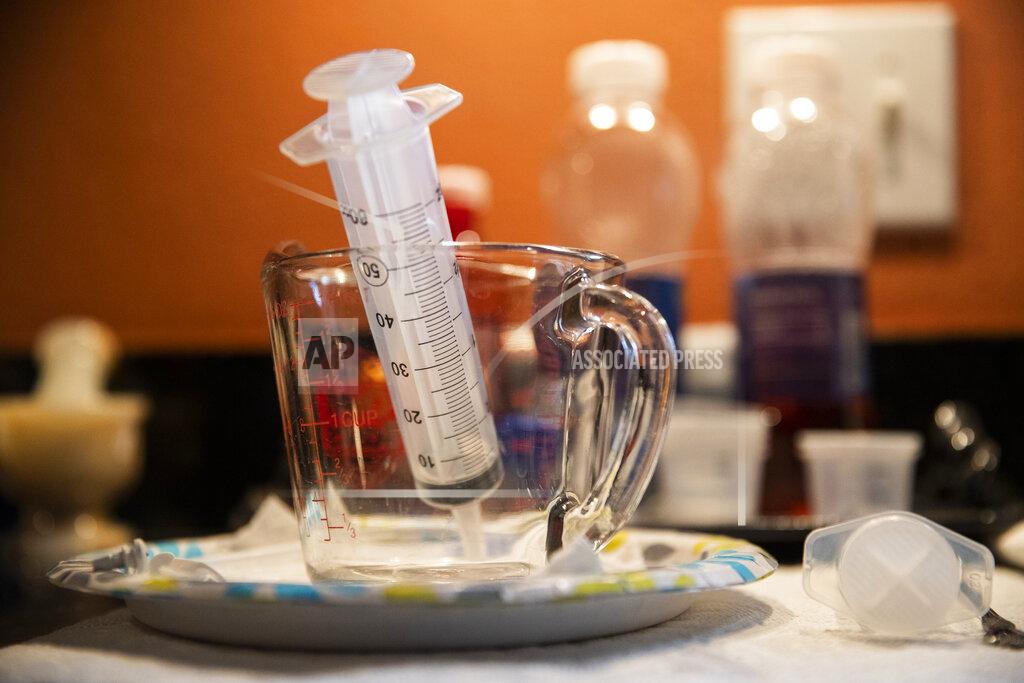 Sophia Germer A syringe used to give Lauren water, sits in a cup at Sue Roesky's home in Metairie, La., Friday, Sept. 17, 2021. (Sophia Germer/The Times-Picayune/The New Orleans Advocate via AP)