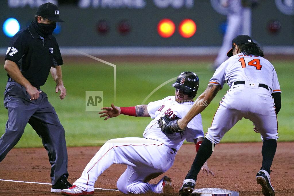 Charles Krupa Baltimore Orioles' Rio Ruiz (14) tags out Boston Red Sox's Christian Vazquez, center, on a steal attempt at third base during the second inning of a baseball game at Fenway Park in Boston, Thursday, Sept. 24, 2020. At left is umpire Ben May. (AP Photo/Charles Krupa)